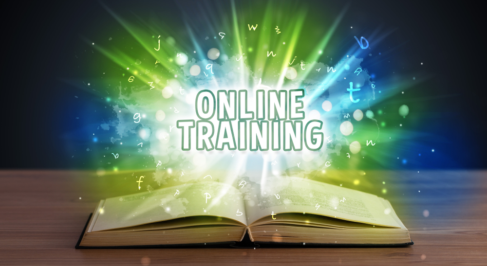 ONLINE TRAINING inscription coming out from an open book, educational concept